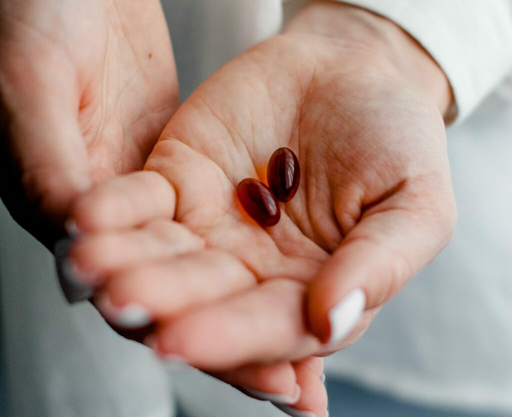 Gel capsule pills in woman's hand